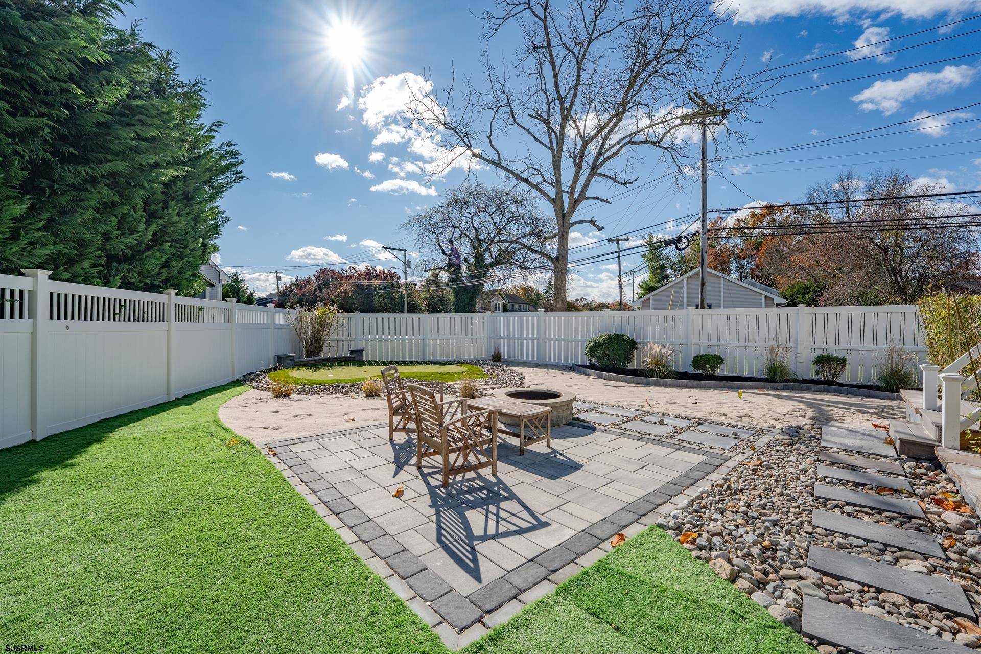 1203 West Mill Road Northfield, NJ 08225 - Photo 34 of 90 a view of a backyard with a wooden fence