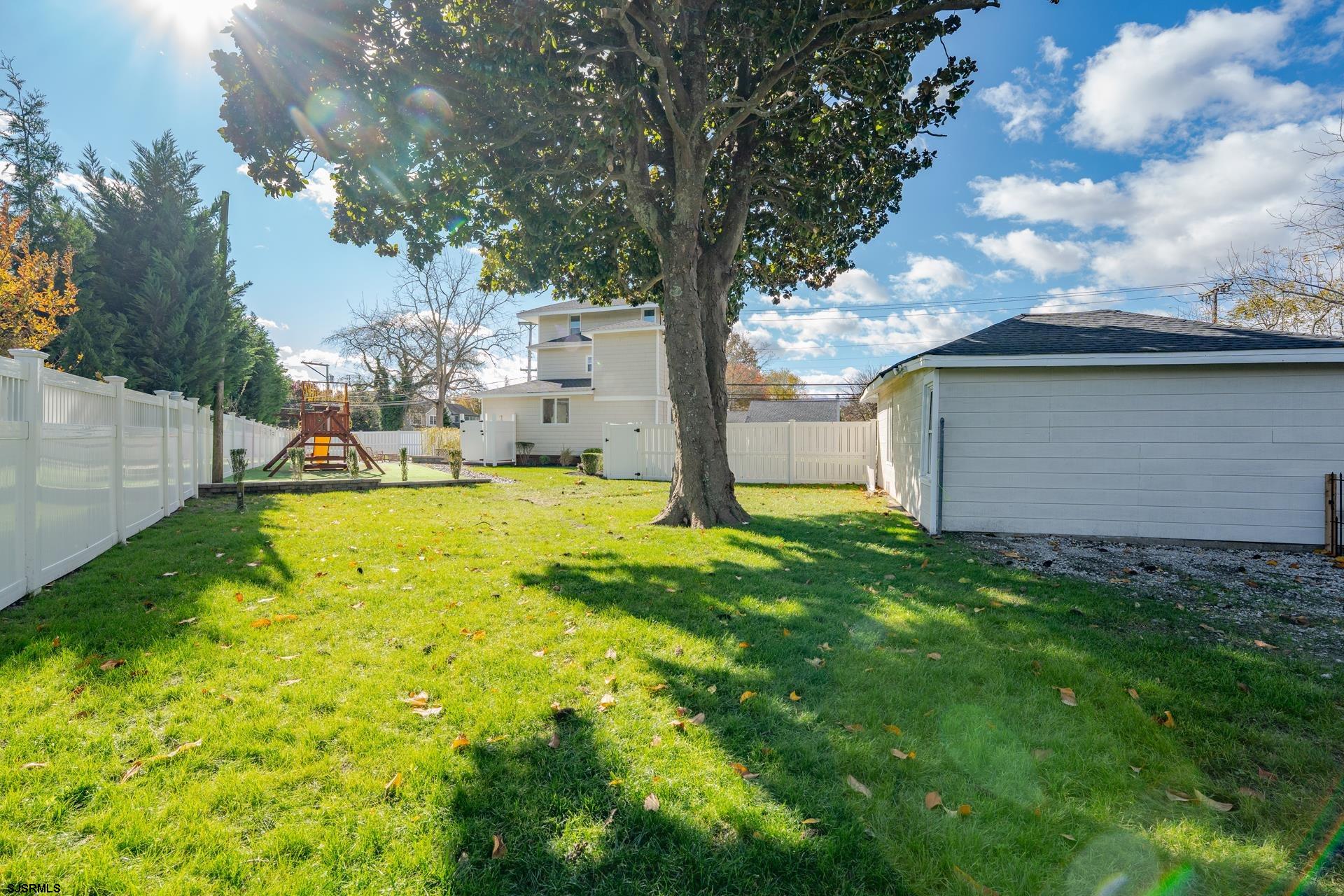 1203 West Mill Road Northfield, NJ 08225 - Photo 45 of 90 a view of back yard of the house along with trees