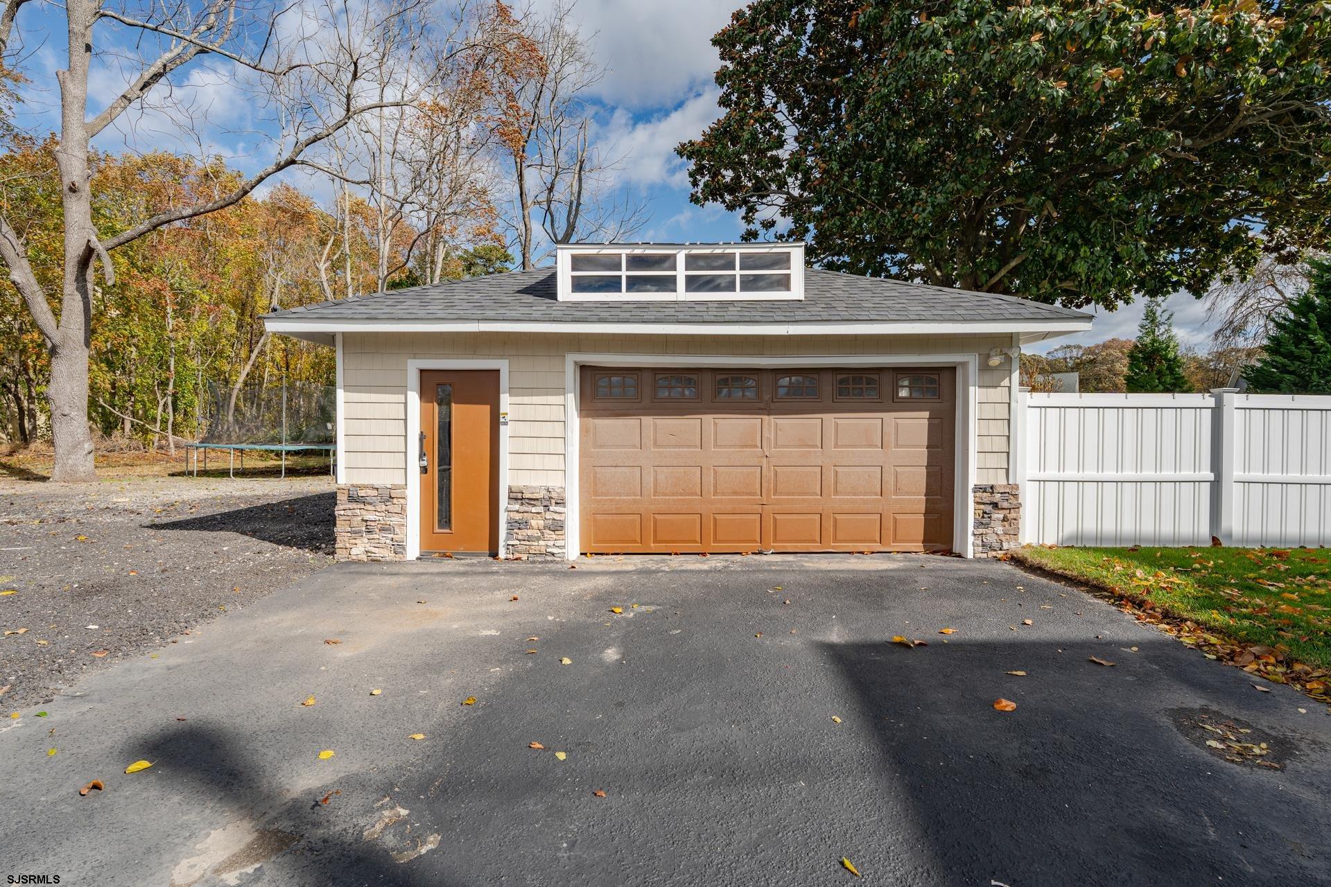 1203 West Mill Road Northfield, NJ 08225 - Photo 47 of 90 a front view of a house with a garage