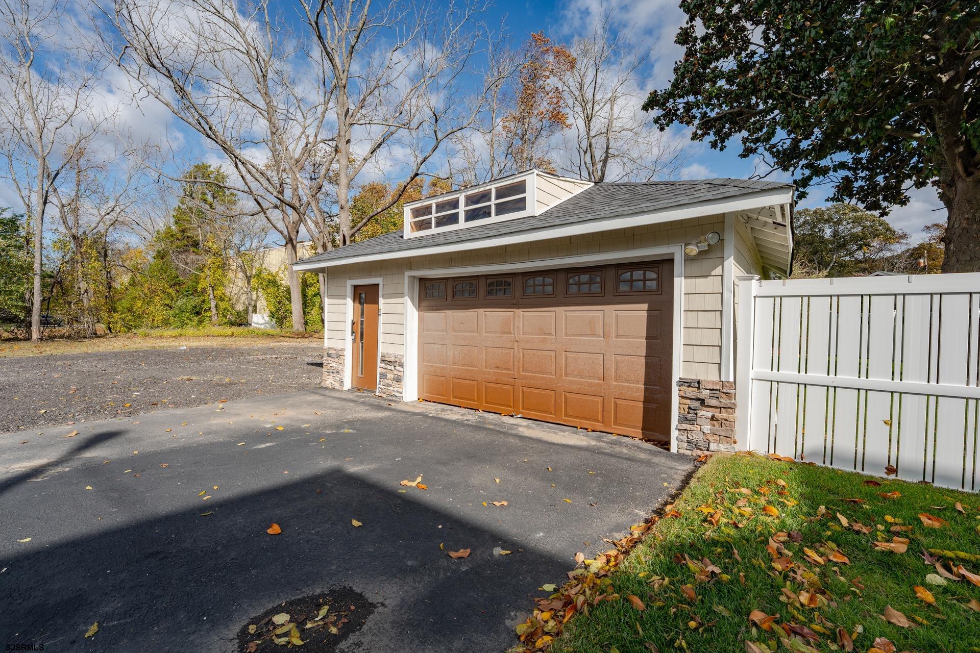 1203 West Mill Road Northfield, NJ 08225 - Photo 48 of 90 a front view of a house with a garage