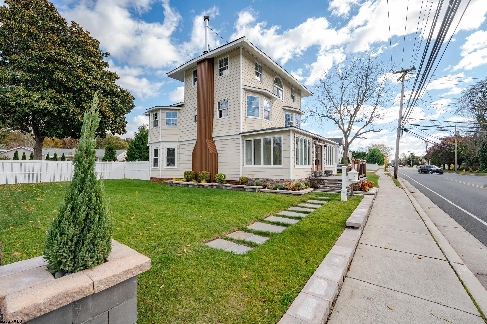 1203 West Mill Road Northfield, NJ 08225 - Photo 54 of 90 a front view of a house with a yard and fountain