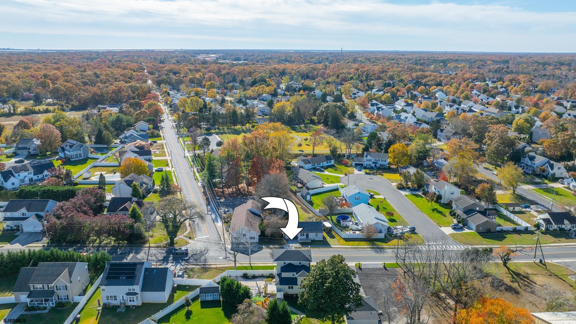 1203 West Mill Road Northfield, NJ 08225 - Photo 76 of 90 an aerial view of a city with lots of residential buildings ocean and mountain view in back