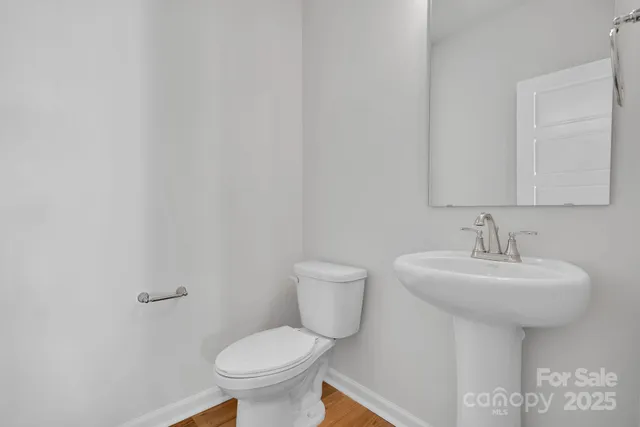 a bathroom with a sink a toilet and mirror