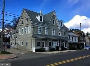 a front view of a residential apartment building with a yard