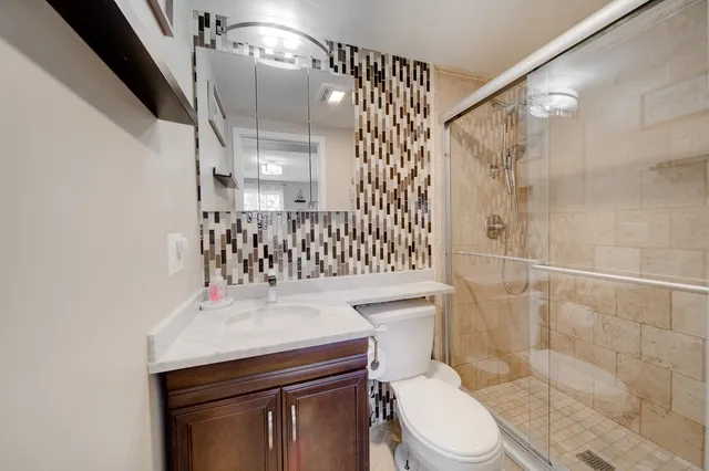 a bathroom with a sink toilet and shower