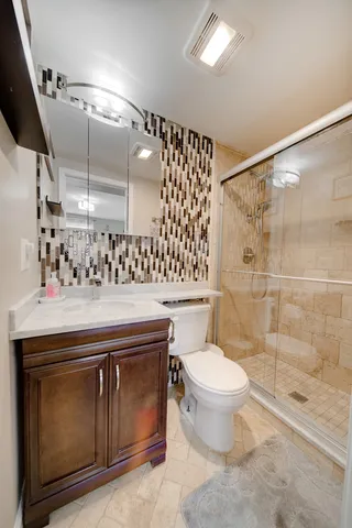 a bathroom with a sink toilet and shower