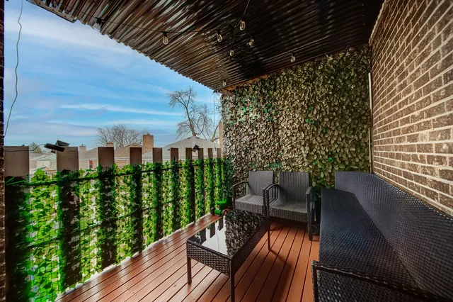 a view of a balcony with chairs