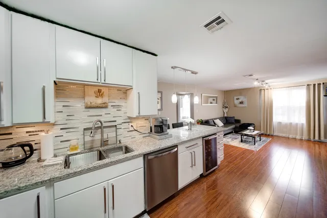 a kitchen with sink stove and cabinets