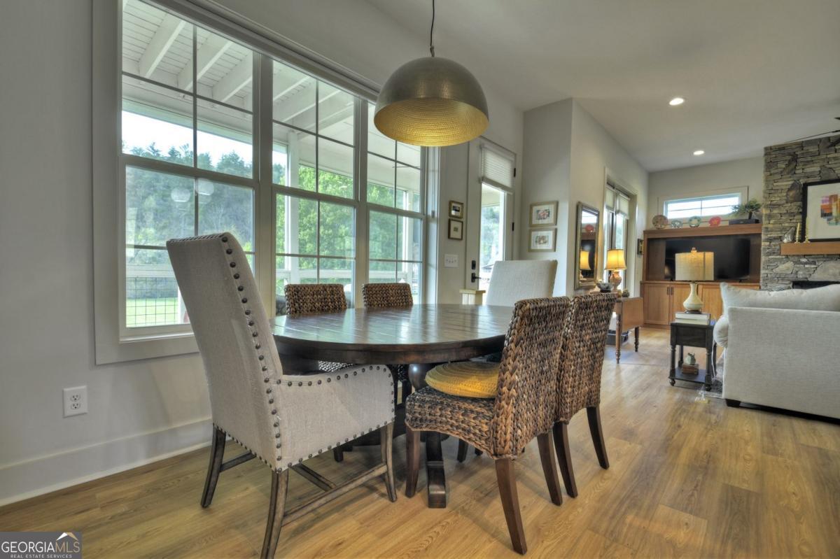 47 Downy Road, Unit 2 Blue Ridge, GA 30513 - Photo 34 of 95 a dining room with furniture a chandelier and wooden floor