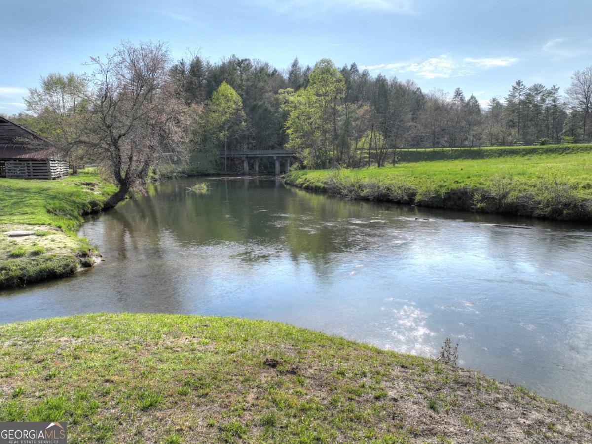 47 Downy Road, Unit 2 Blue Ridge, GA 30513 - Photo 43 of 95 a view of a lake next to a building with trees in the background