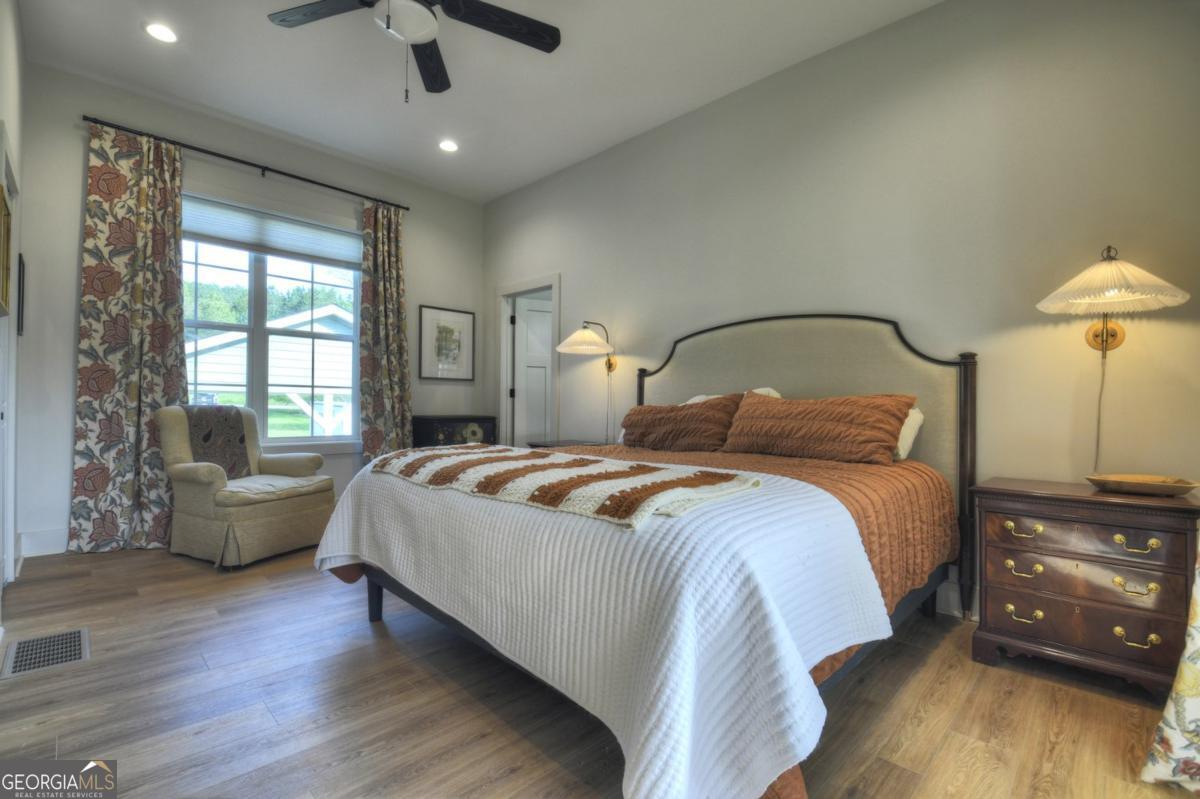 47 Downy Road, Unit 2 Blue Ridge, GA 30513 - Photo 49 of 95 a bedroom with a bed and wooden floor