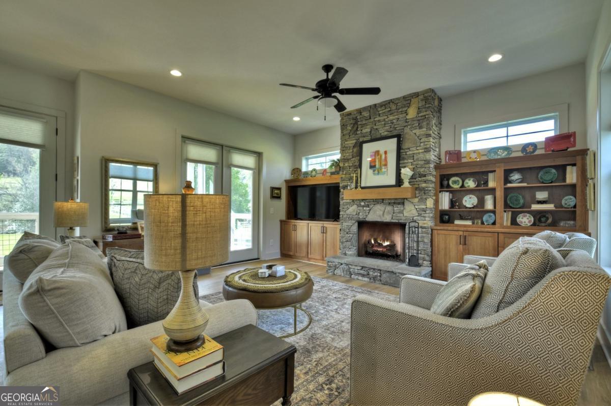 47 Downy Road, Unit 2 Blue Ridge, GA 30513 - Photo 50 of 95 a living room with furniture a fireplace and a chandelier