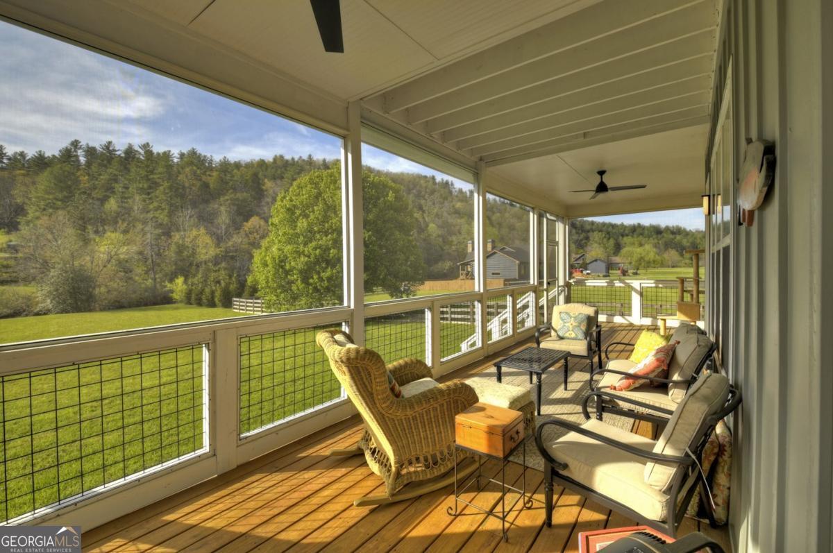 47 Downy Road, Unit 2 Blue Ridge, GA 30513 - Photo 59 of 95 a view of a chair and tables in the balcony