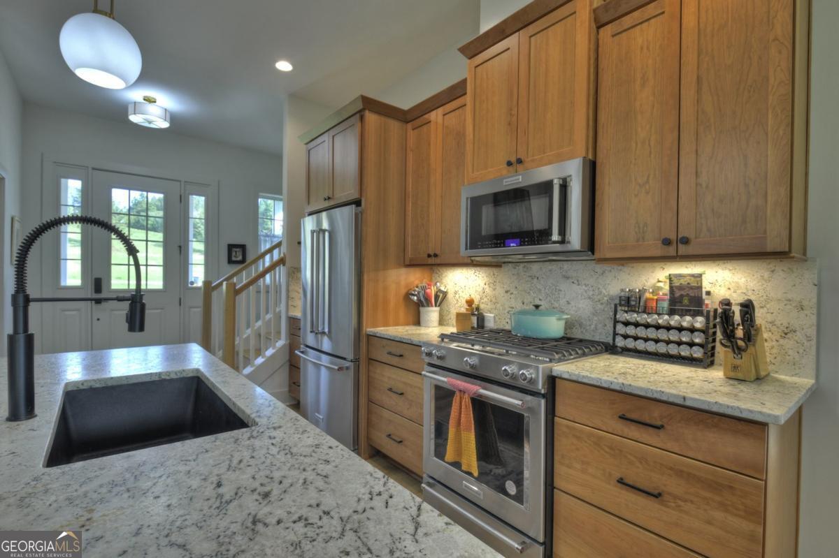 47 Downy Road, Unit 2 Blue Ridge, GA 30513 - Photo 95 of 95 a kitchen with stainless steel appliances granite countertop a stove a sink and a microwave