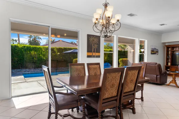 a view of a dining room with furniture wooden floor and chandelier