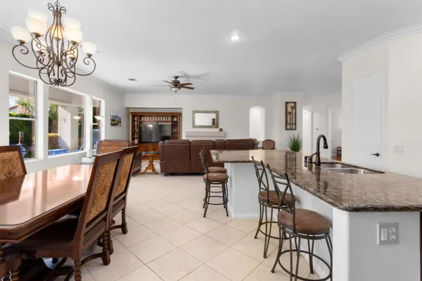 a view of a dining room with furniture and a chandelier