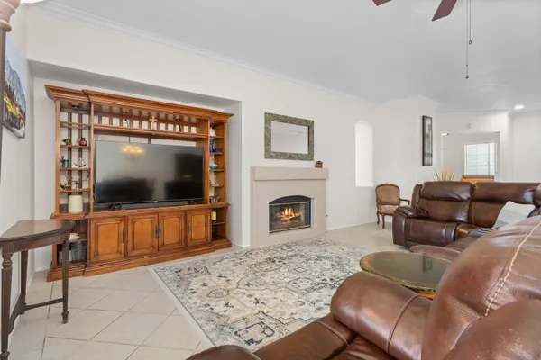 a living room with furniture a flat screen tv and a fireplace