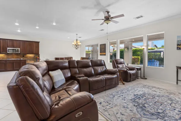 a living room with furniture ceiling fan and a rug