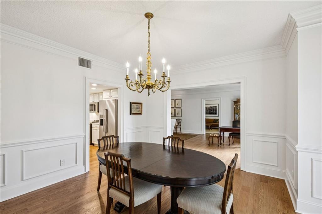 2765 Peachtree Road Northeast, Unit 3 Atlanta, GA 30305 - Photo 11 of 30 a view of a dining room with furniture wooden floor and chandelier