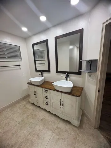 a bathroom with 2 sink tub and a mirror