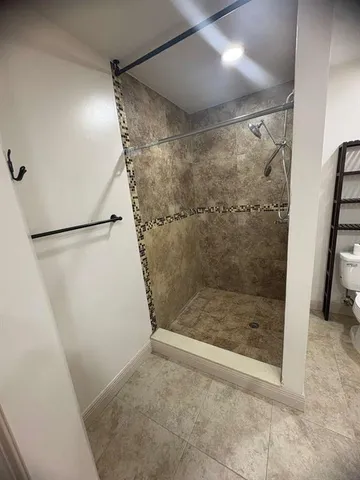 a bathroom with a glass shower door