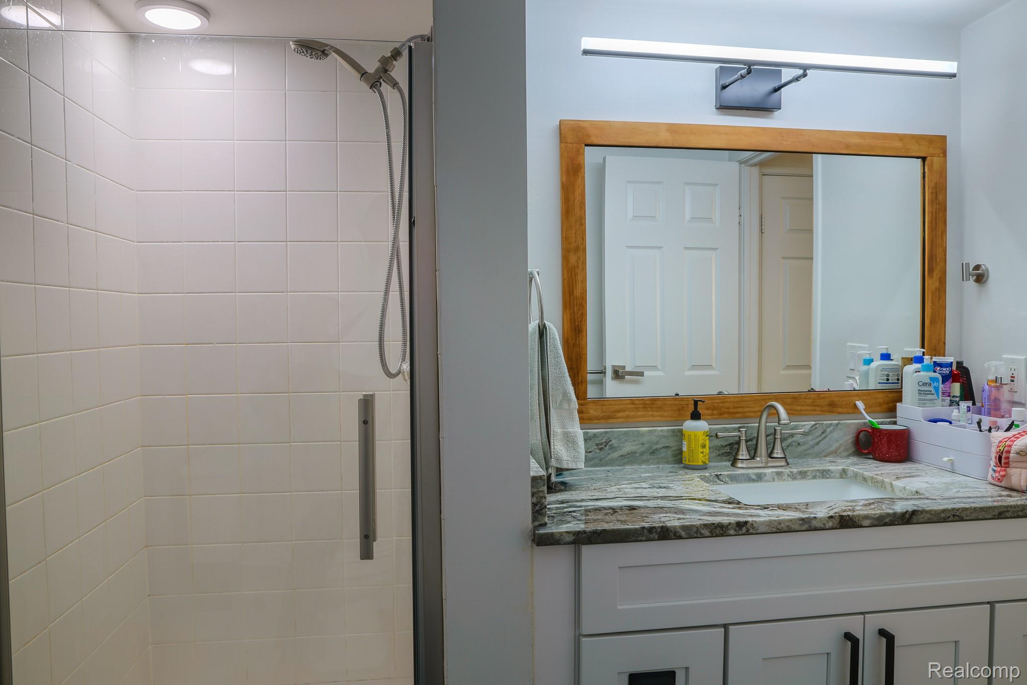 1989 Klingensmith Road, Unit 46 Bloomfield Hills, MI 48302 - Photo 31 of 41 Bathroom featuring a walk-in shower with tile surround, glass enclosure, and recessed lighting
