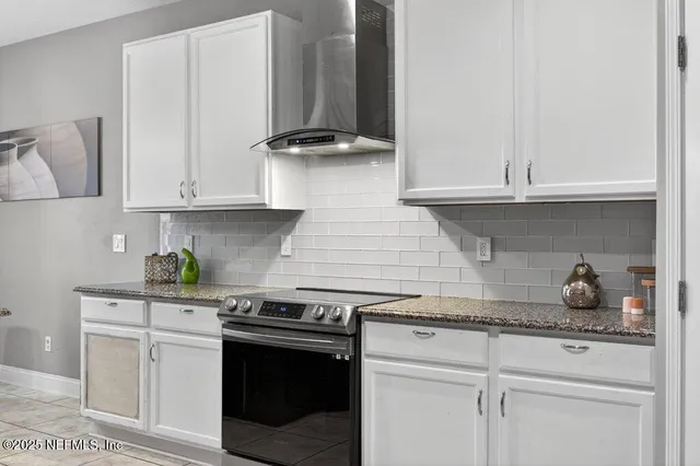 a kitchen with granite countertop a sink and cabinets
