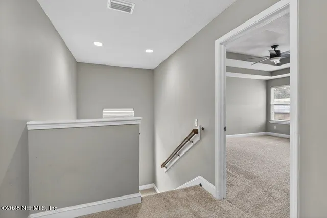 a view of a big room with wooden floor and a ceiling fan