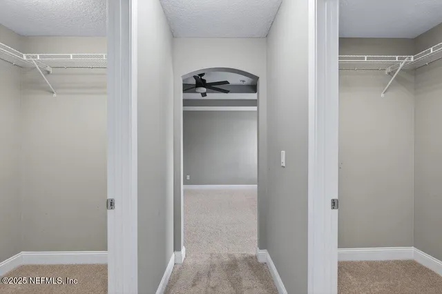 a white bath tub sitting next to a shower
