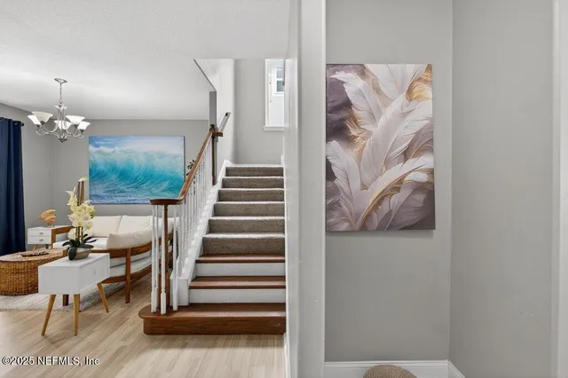 a view of entryway and hall with wooden floor