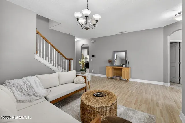 a kitchen with granite countertop a refrigerator stove top oven and sink