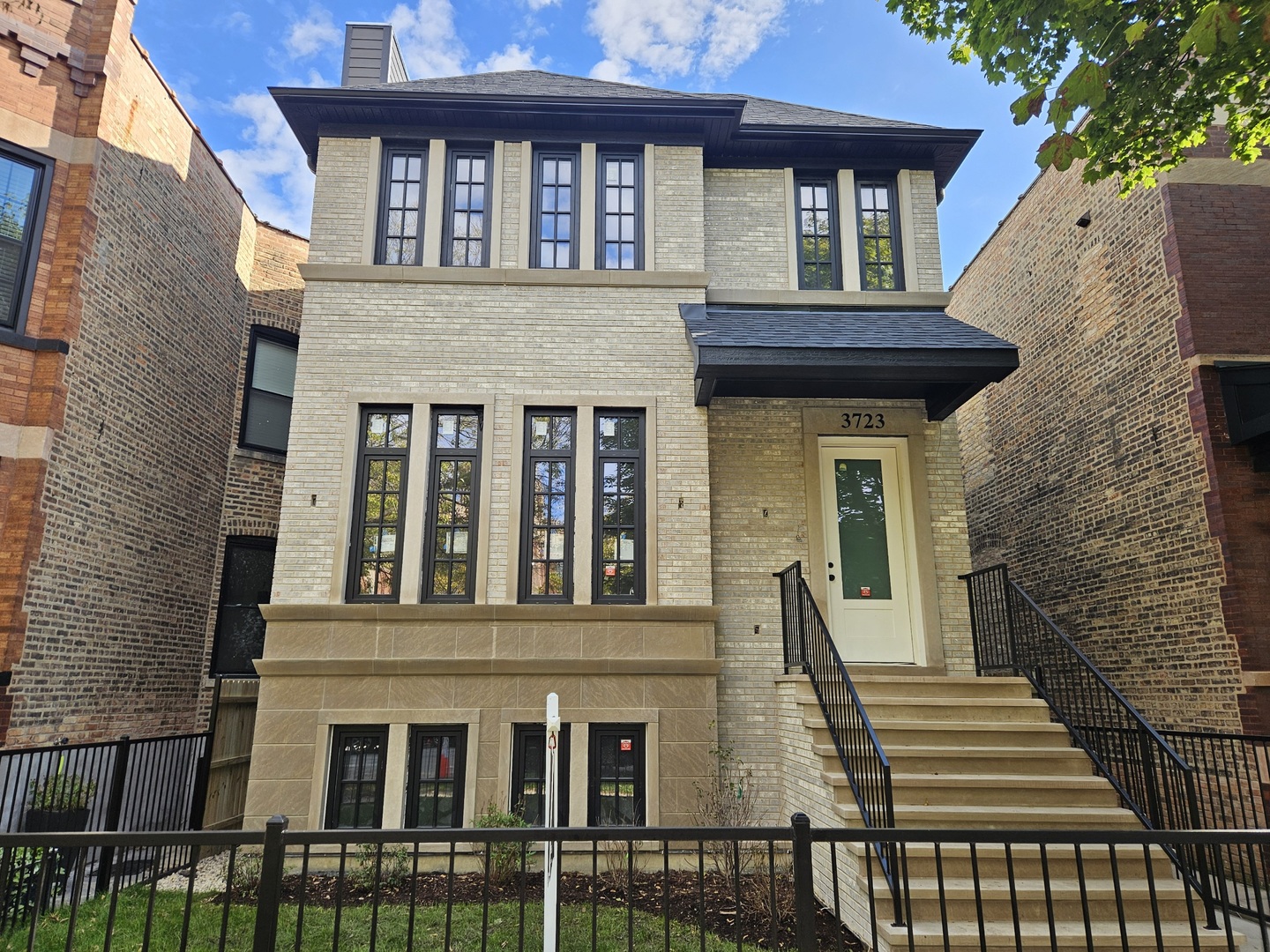a view of a brick house with large windows