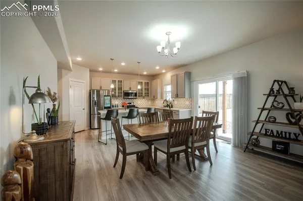 a view of a dining room with furniture and wooden floor