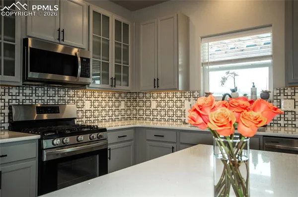 a kitchen with stainless steel appliances a stove a sink and a microwave
