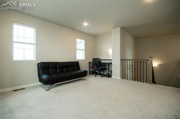 a living room with furniture cabinets and a window