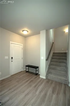 a view of a room with wooden floor and stairs
