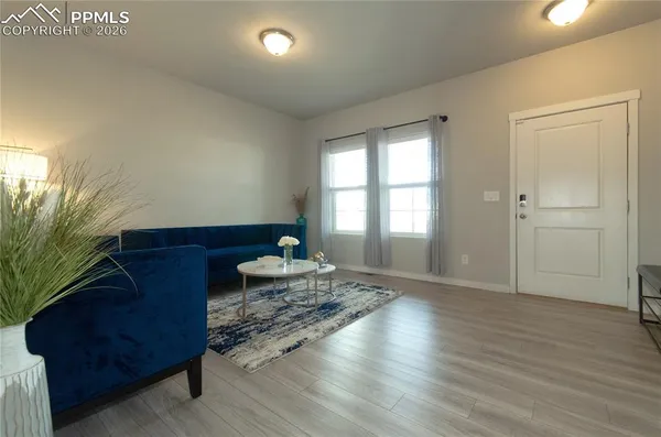 a living room with hard wood flooring and a couch
