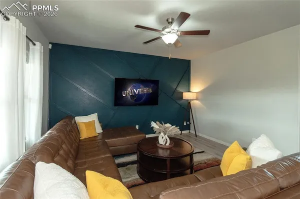 a living room with furniture and a lamp