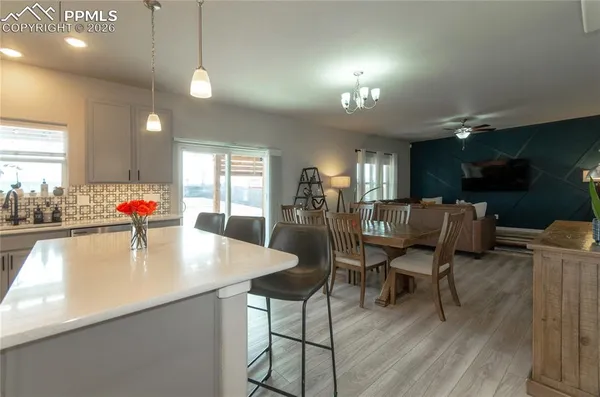 a kitchen with dining table and chairs