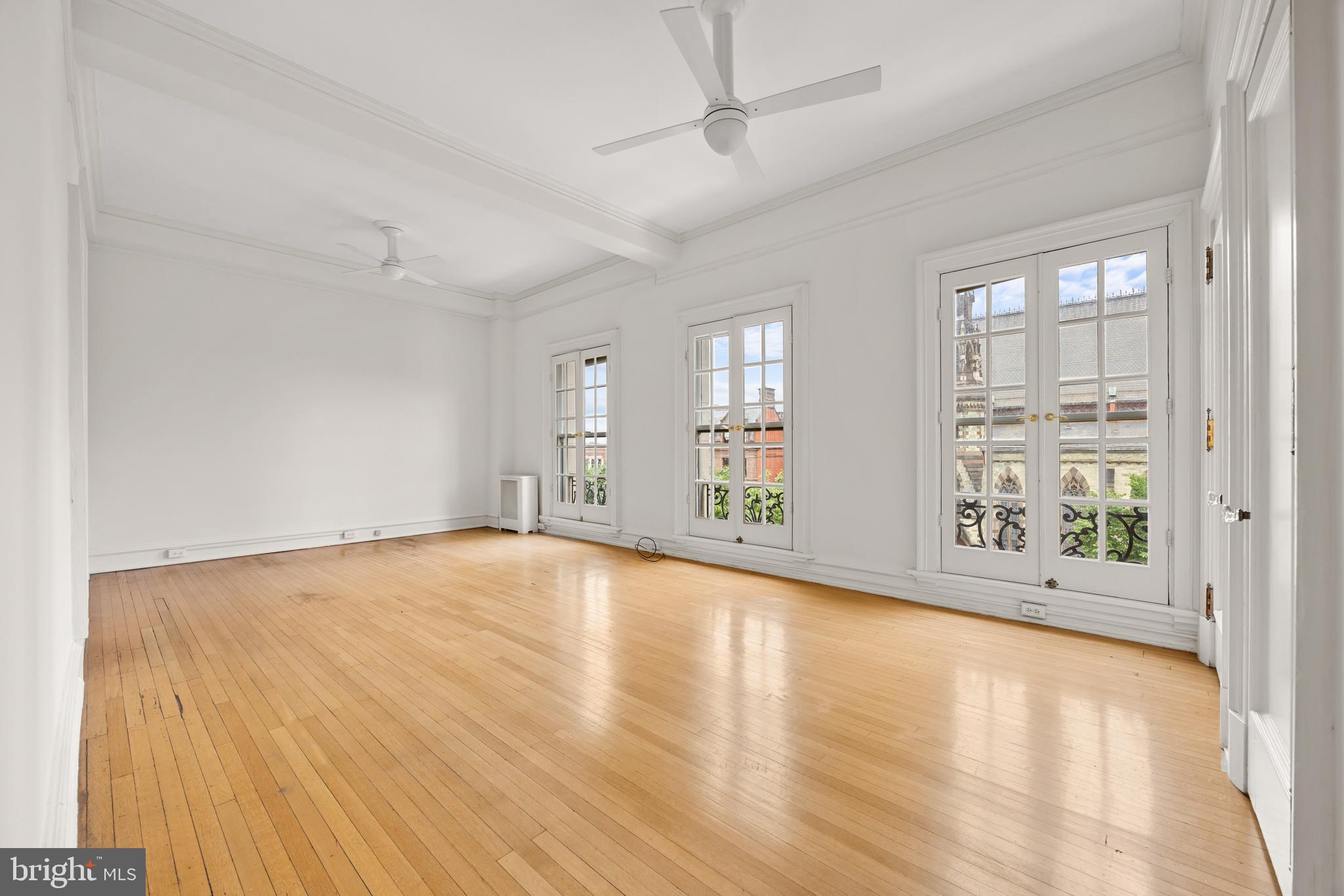 700 Washington Place, Unit 4B Baltimore, MD 21201 - Photo 22 of 67 an empty room with wooden floor and windows