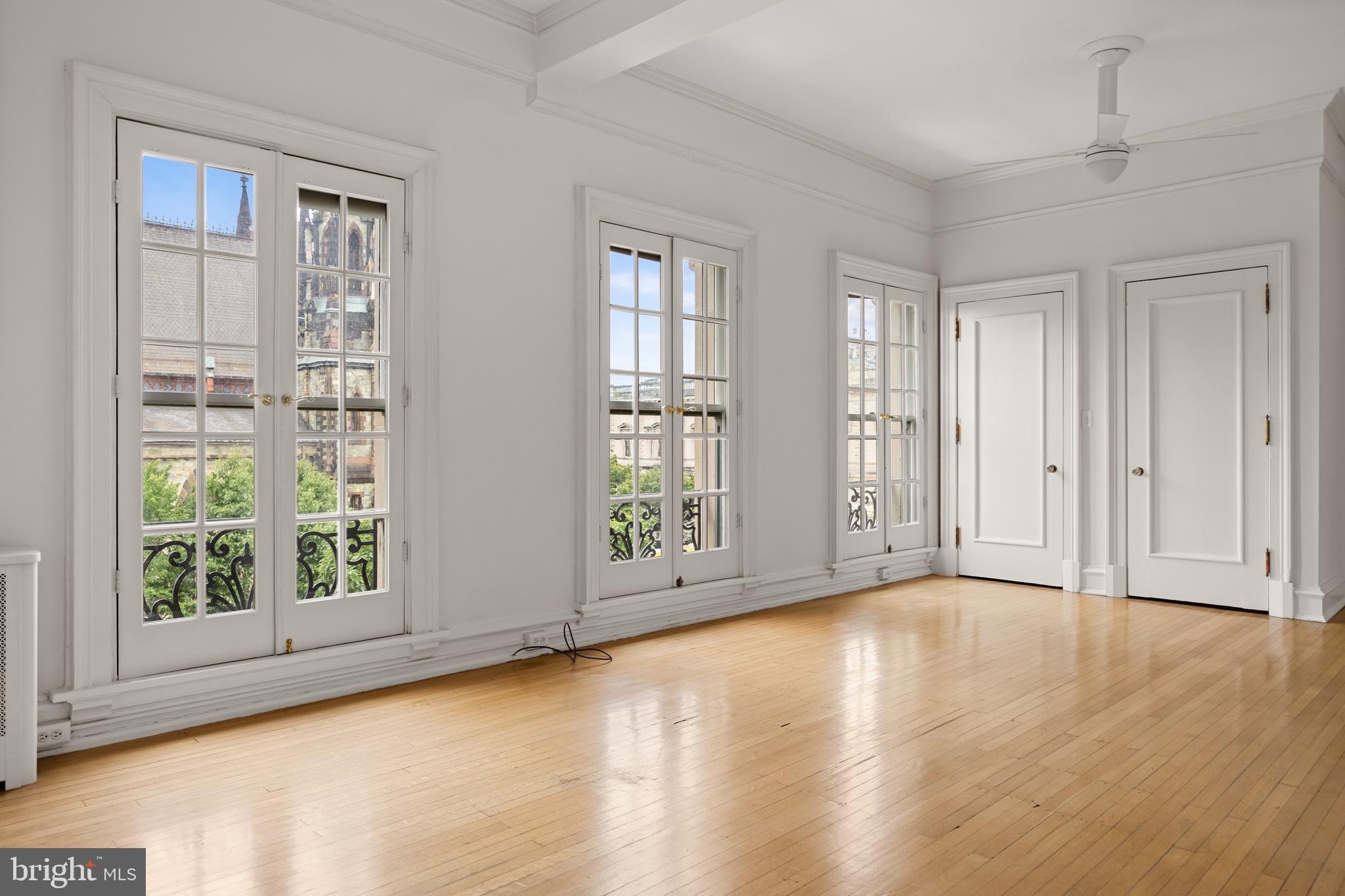 700 Washington Place, Unit 4B Baltimore, MD 21201 - Photo 27 of 67 an empty room with wooden floor and windows
