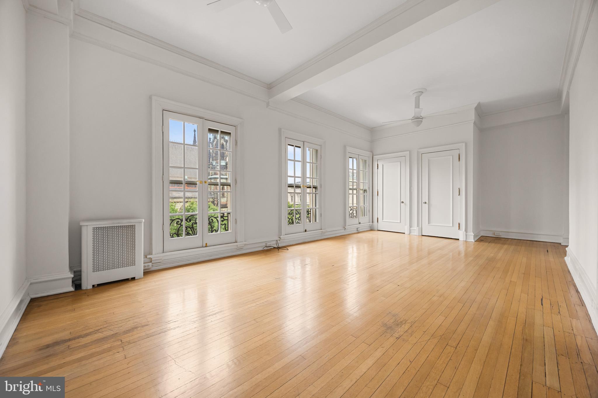 700 Washington Place, Unit 4B Baltimore, MD 21201 - Photo 28 of 67 a view of an empty room with wooden floor and a window