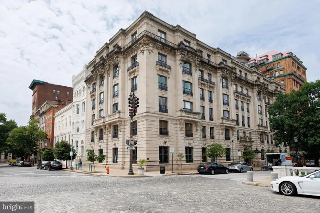a view of hallway with wooden floor and stairs