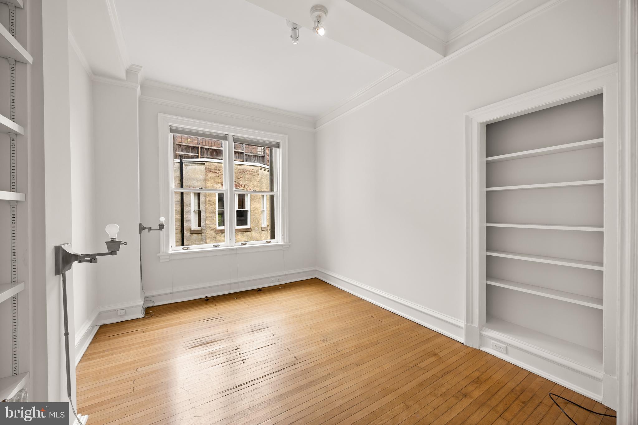 700 Washington Place, Unit 4B Baltimore, MD 21201 - Photo 34 of 67 a view of an empty room with a window and wooden floor