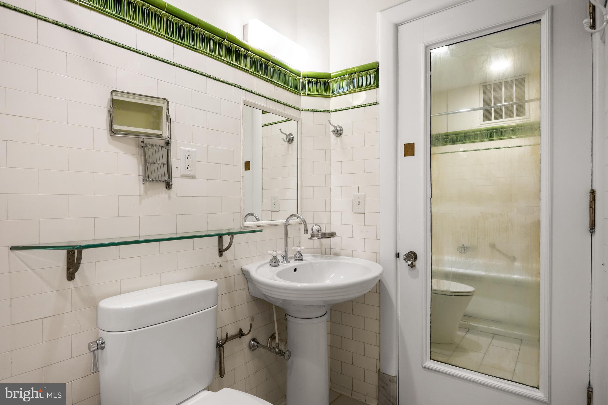 700 Washington Place, Unit 4B Baltimore, MD 21201 - Photo 41 of 67 a bathroom with a sink a toilet and shower
