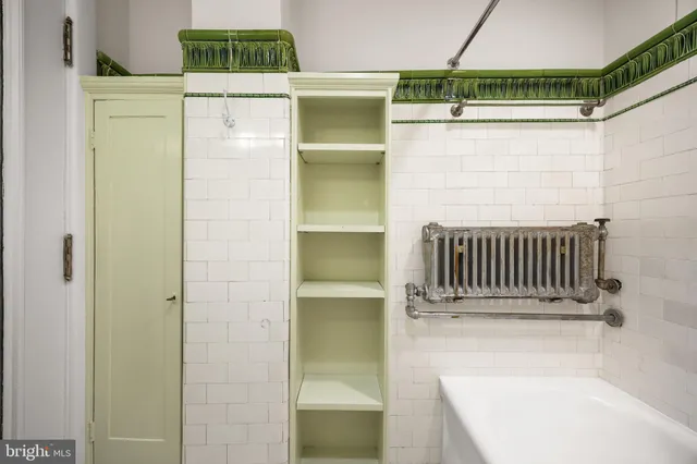 a kitchen with granite countertop white cabinets and white stainless steel appliances