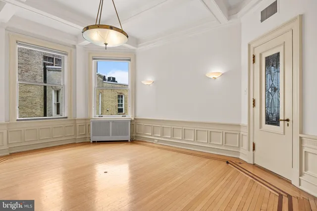 a kitchen with stainless steel appliances granite countertop white cabinets and a stove a oven with white countertops