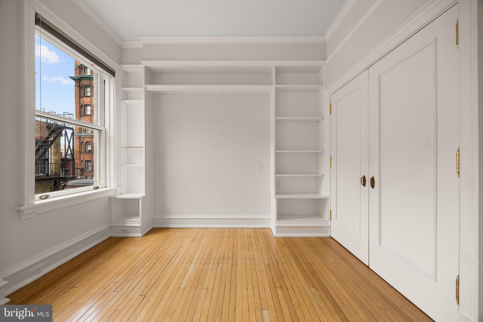 700 Washington Place, Unit 4B Baltimore, MD 21201 - Photo 48 of 67 a view of an empty room with wooden floor and a window
