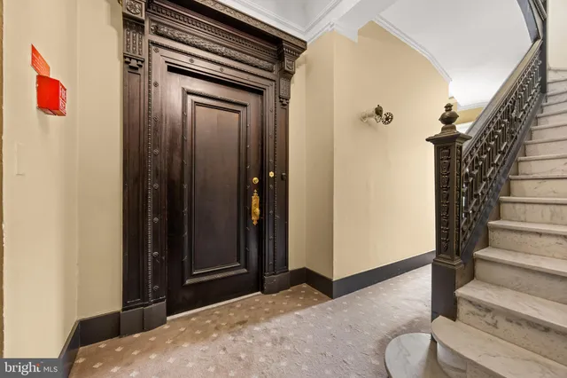 a view of a room with wooden floor and a window