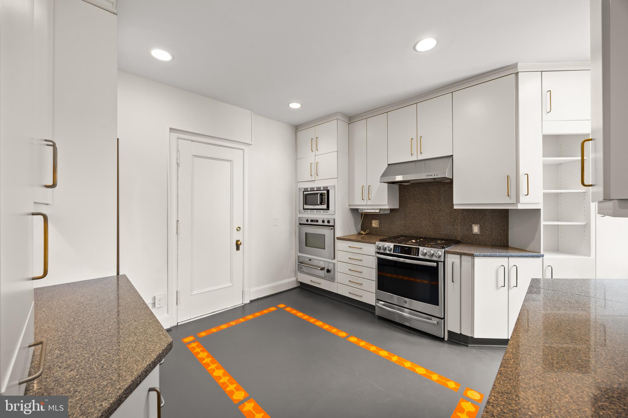 700 Washington Place, Unit 4B Baltimore, MD 21201 - Photo 52 of 67 a kitchen with stainless steel appliances granite countertop a stove a sink and a refrigerator